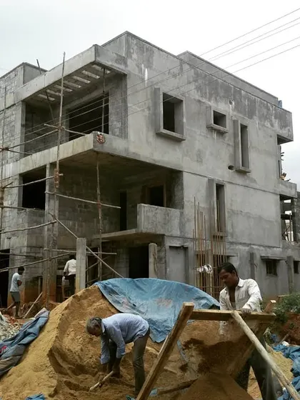 A typical day on site. This photo shows a residence in Uttarahalli during the structural phase, with the concrete frame and blockwork going up. I personally supervise every stage of construction.
