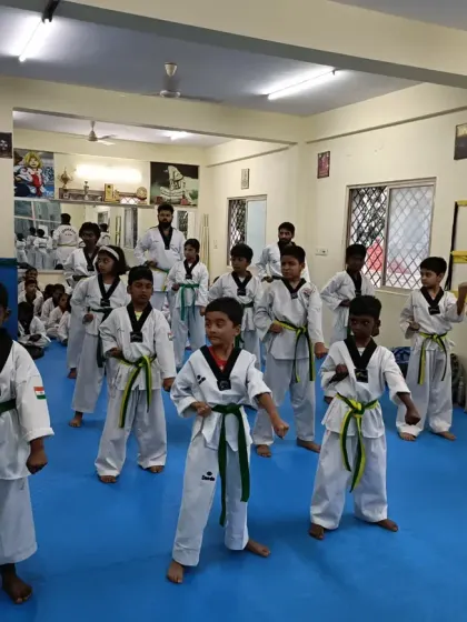 A class of green belts in their fighting stance, ready for action.