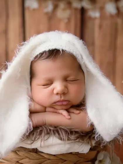 Some bunny is new here! This close-up shot focuses on the adorable face and the soft, fuzzy texture of the bunny ears.