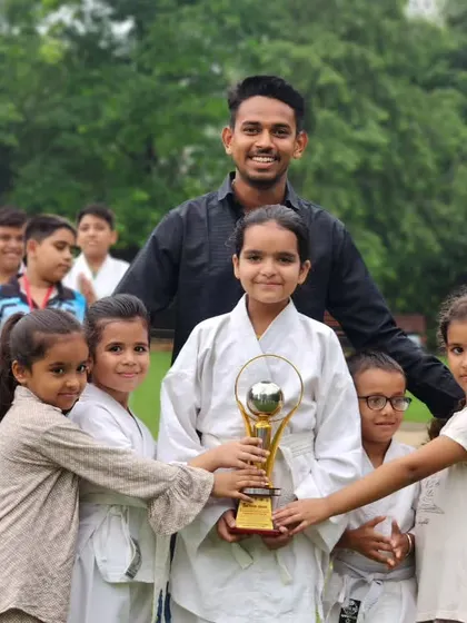 This trophy isn't just metal, it's proof of our collective hard work. I am incredibly proud of my young fighters who hold it high. We win as a family.
