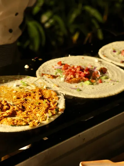Here you can see the variety at my live dosa counter, with different fillings being prepared side-by-side. I can customize each dosa to your guests' preferences, ensuring everyone gets exactly what they crave.