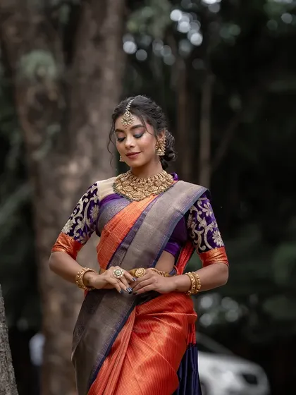 A moment of quiet grace, the model's pose reflecting the timeless elegance of the Kanchipuram silk saree.