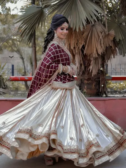 Capturing the perfect twirl, this photo shows the full flare of the bride's shiny, off-white skirt. The motion blur adds a sense of energy and happiness.