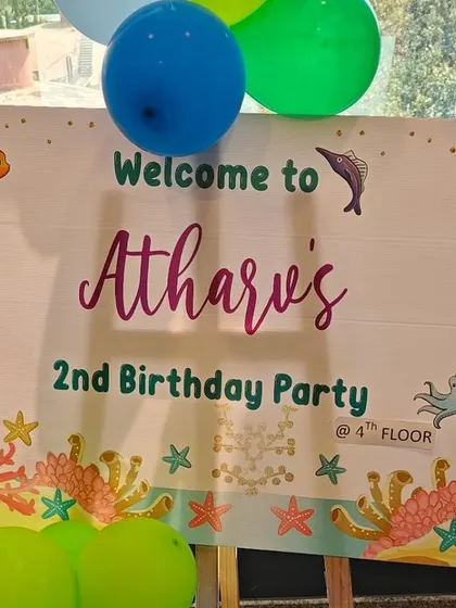 A colorful welcome sign for Atharv's 2nd birthday party, setting the stage for an underwater adventure. The sign features cute sea creatures and fun typography.