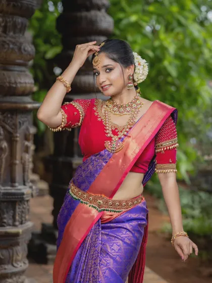 A full view of the bride, showcasing the vaddanam and how it enhances the silhouette of the saree. The complete set creates a truly memorable bridal look.
