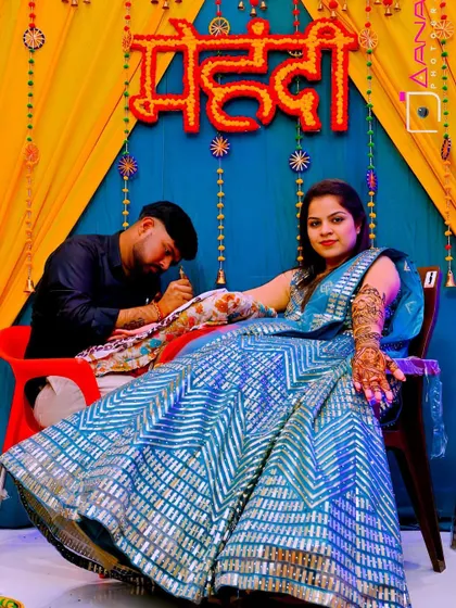 A professional shot of me working at a client's mehandi ceremony, set against a beautiful, festive backdrop.