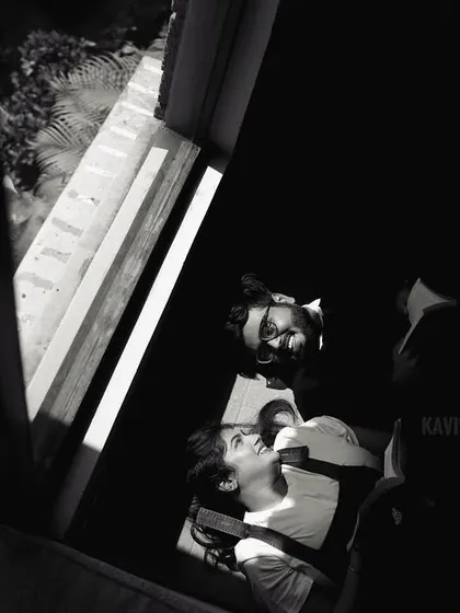 A creative overhead shot in black and white, capturing the couple in a unique and artistic way during their pre-wedding session.