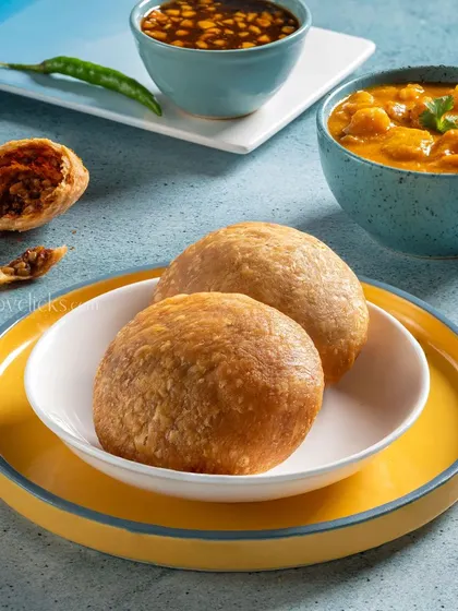 A different angle of Kachori with aloo curry, presented in colorful tableware to create a vibrant image.