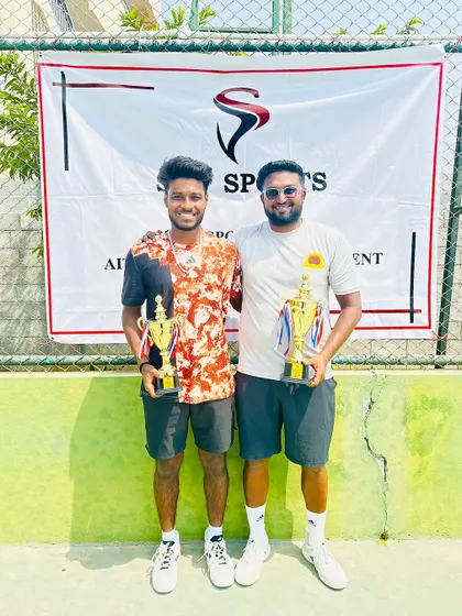 Coach Mohit with a doubles finalist, celebrating a successful tournament week.