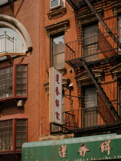 Architectural details and signage on a brick building in New York's Chinatown. I often focus on these small vignettes that give a neighborhood its unique visual identity.