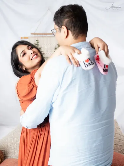 A sweet and playful moment, with the mom-to-be holding the baby shoes. These are the little details that make a session personal.
