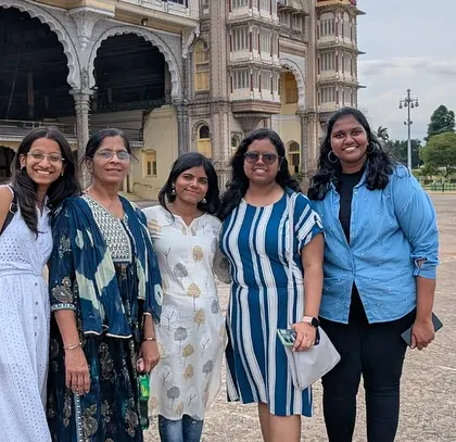 A group of friends enjoying the grandeur of the Mysore Palace grounds. It's a perfect backdrop for memorable pictures.