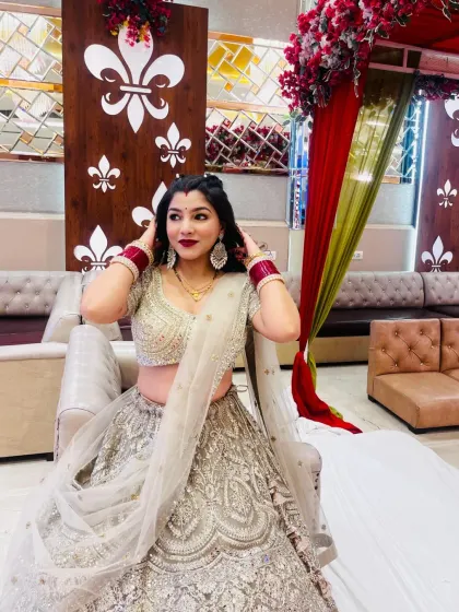 A series of photos of my happy client looking absolutely stunning in a heavily embroidered silver-grey lehenga at her reception. She owned the look completely!