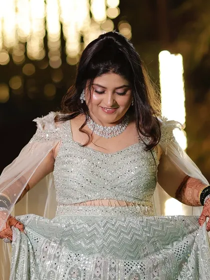 A closer look at her beautiful lehenga and the makeup that complements it. The soft pink tones on her eyes and lips tie the whole look together.
