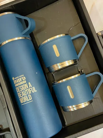 Here's what's inside the golden box: a stylish branded thermos and mug set from INIFD, showcasing our ability to source and customize high-quality merchandise.