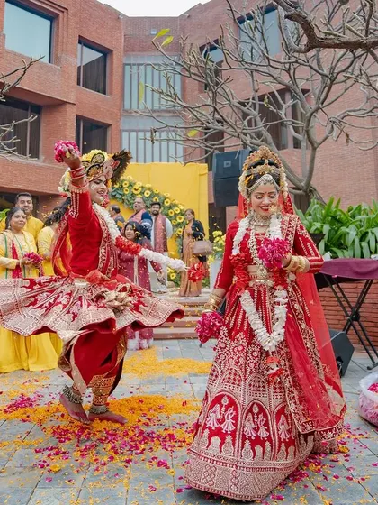 A breathtaking performance by dancers dressed as Radha and Krishna at a haldi ceremony. This wide shot captures the grandeur and spiritual beauty of the moment.