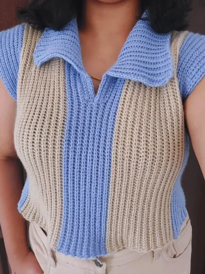 A close-up view of the Knit-Like Sweater Vest, highlighting the vertical stripes and polo collar.