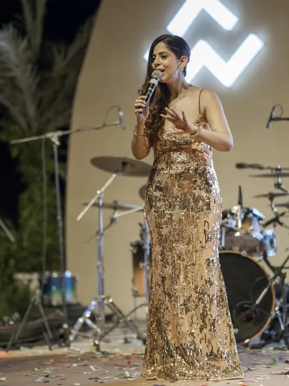 A solo moment on stage, holding the mic at the WAL Developments event. This shot captures the essence of my role: to be the confident, guiding voice of the evening.