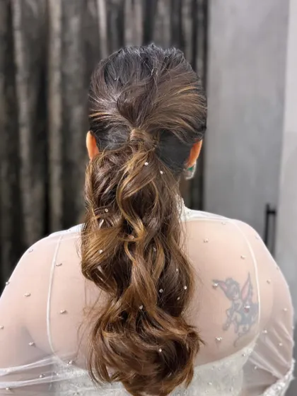 A back view of the messy ponytail, showing the subtle diamond pin details.