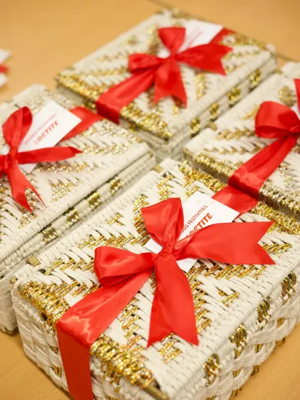 A stack of custom Diwali boxes for Loctite, finished with a vibrant red ribbon. This shows how a simple color choice can make branded packaging pop and feel extra festive.