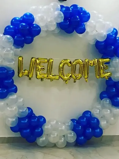 A simple and clean "Welcome" ring in blue and white balloons with gold foil letters.