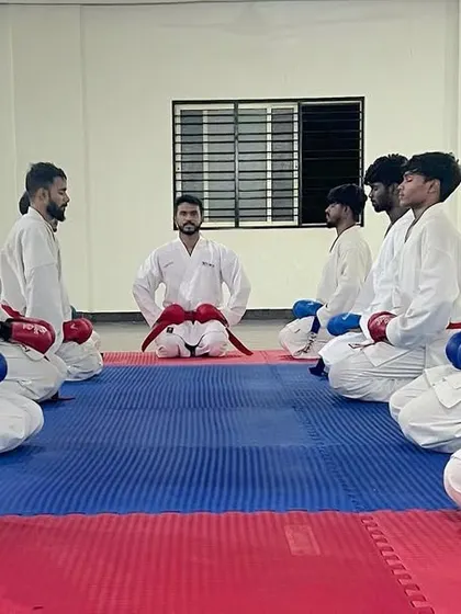 To become a champion, you must train under a champion. Our team sits with their coach, ready to learn.