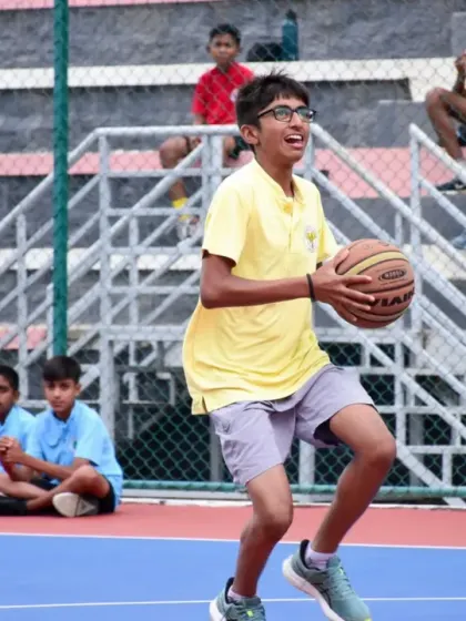 A player looks for an open teammate, demonstrating the court awareness and teamwork we emphasize in our basketball program.