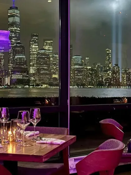 A table with a view at LokalJC, looking out at the iconic Tribute in Light in Manhattan. Our design prioritizes the connection to the location, ensuring the view is always the star.