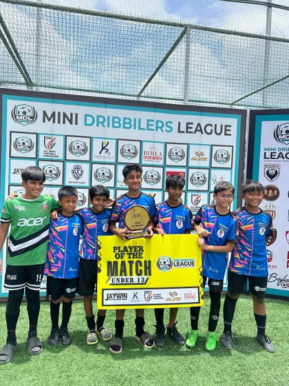 Our U13 team celebrating with their 'Player of the Match' award after a successful game.