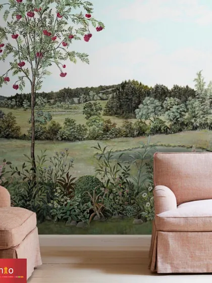 The 'Rowan' wallpaper by Nobilis transforms this living room into a serene pastoral landscape. The design features a delicate tree and rolling hills, creating a peaceful and sophisticated garden setting.