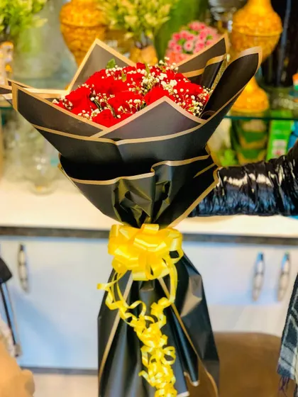 Another angle of the elegant red rose bouquet, showcasing the sharp lines of the Korean-style black wrapping.