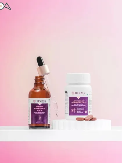A shot of a hair growth serum and supplement bottle against a gradient pink background, showcasing a product duo.