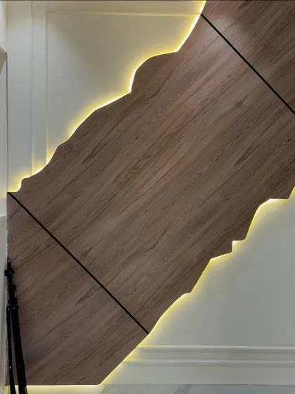 A close-up of the custom-designed wooden wall panel with integrated LED lighting, highlighting the craftsmanship and attention to detail.
