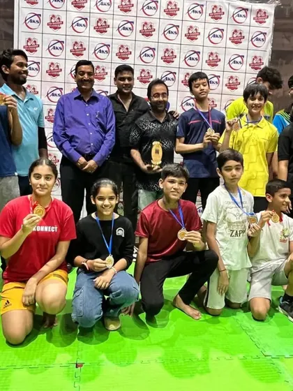 The AKS family celebrating together after a successful tournament. Seeing my players with their medals and trophies is the result of all the hard work we put in on the court.