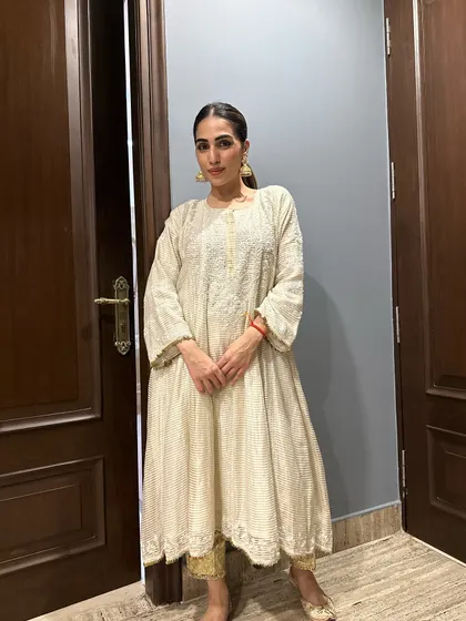A full-length shot of the chikankari anarkali. The intricate embroidery and classic silhouette make it a timeless piece.