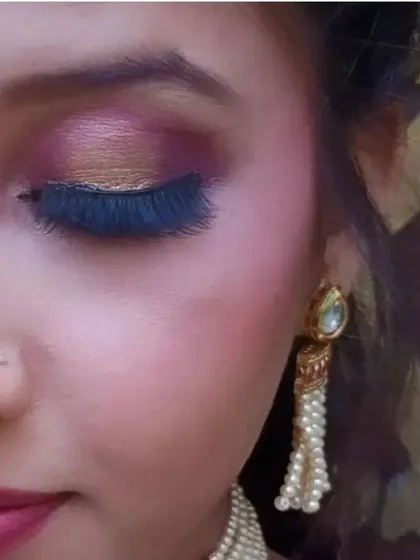 A close-up of a beautiful pink and gold glitter eye makeup look, perfect for festive occasions.