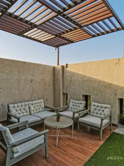 An outdoor terrace designed as a breakout space for Shailja Papers Ltd. This design and build project included creating relaxing environments like this, complete with comfortable seating and a pergola for shade.