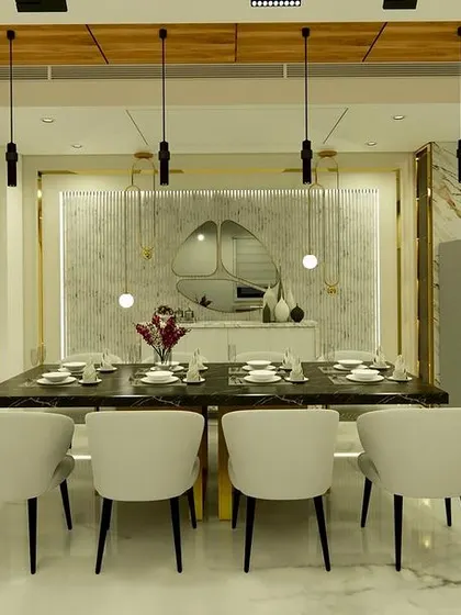 A frontal view of the dining table, looking towards the open kitchen and a beautifully lit crockery unit.