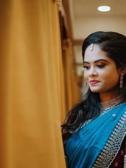 A portrait of the bride looking out a window, her expression serene as she anticipates the ceremony.