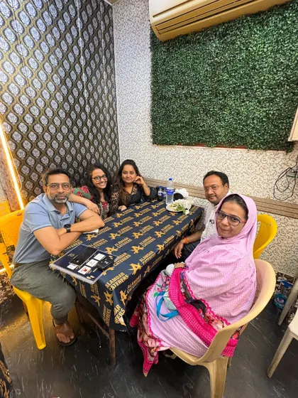 A family enjoying their dinner at a table covered with custom linen from our partner, The Urban Mix.