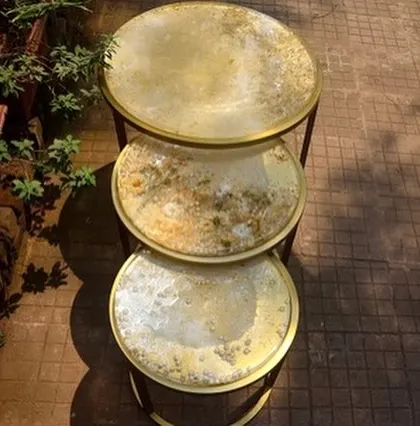 A set of three nesting tables I revamped with a unique, textured gold and white resin finish. This is one of my favorite upcycling projects from over the years.