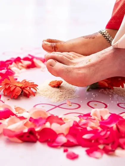 A close up of the Saptapadi ritual, where the couple takes their first seven steps together on a path of rice and rose petals, a detail we thoughtfully arranged.