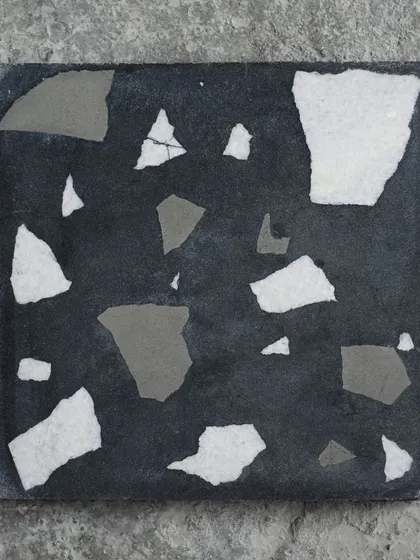 A single tile of the dark Venetian terrazzo, perfect for creating dramatic and sophisticated spaces.