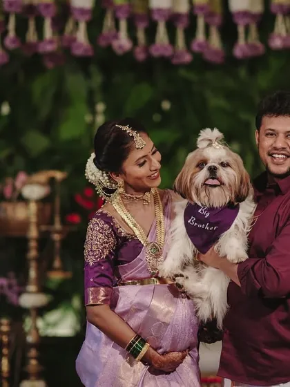 The mom-to-be with her husband and their adorable dog, who is the "big brother." A perfect family portrait from the baby shower.