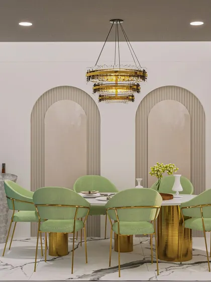 The dining area adjacent to the white kitchen features plush mint green chairs and a dramatic chandelier, creating an elegant transition.