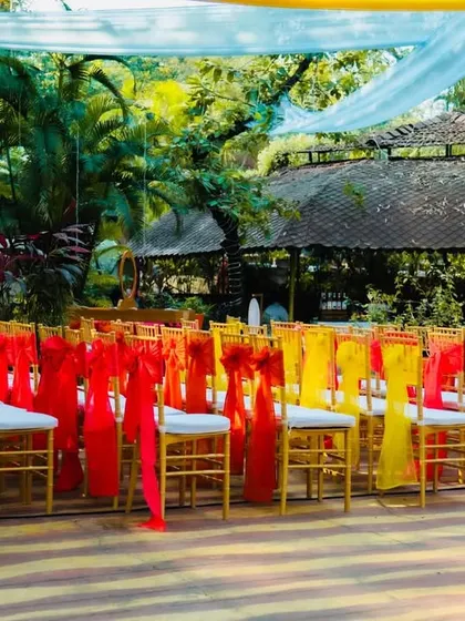 The seating arrangement for the carnival party, with chairs decorated in alternating red and yellow sashes, creating a bright and cheerful look.
