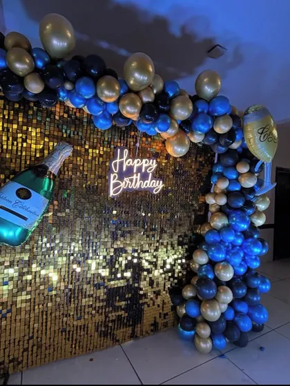A side view of the gold shimmer wall setup, highlighting the depth and texture of the balloon arch.