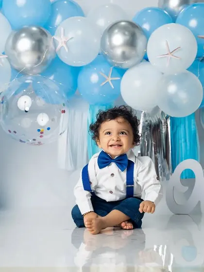 A sweet, happy smile from the one-year-old. Our custom balloon arrangements are designed to perfectly match your chosen birthday theme.