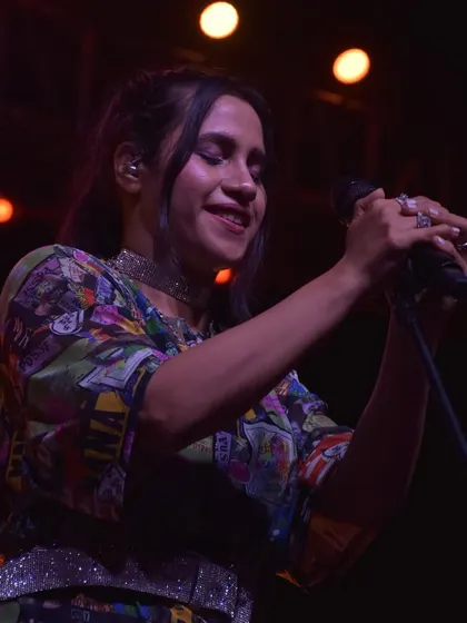 A close-up shot of Nikhita Gandhi enjoying her performance at Ramjas College, DU. We ensure artists feel comfortable and connected on stage.