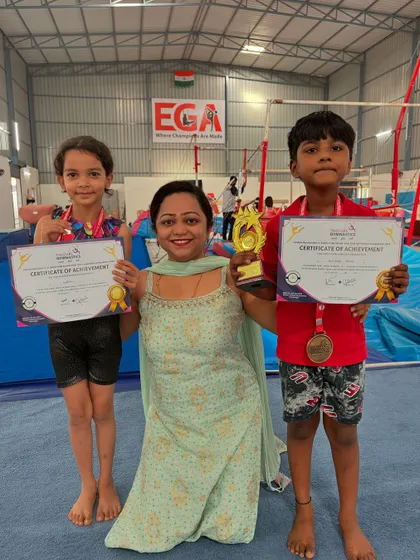 A coach with two of our young winners. We celebrate every achievement, big or small, to foster a positive and motivating environment.